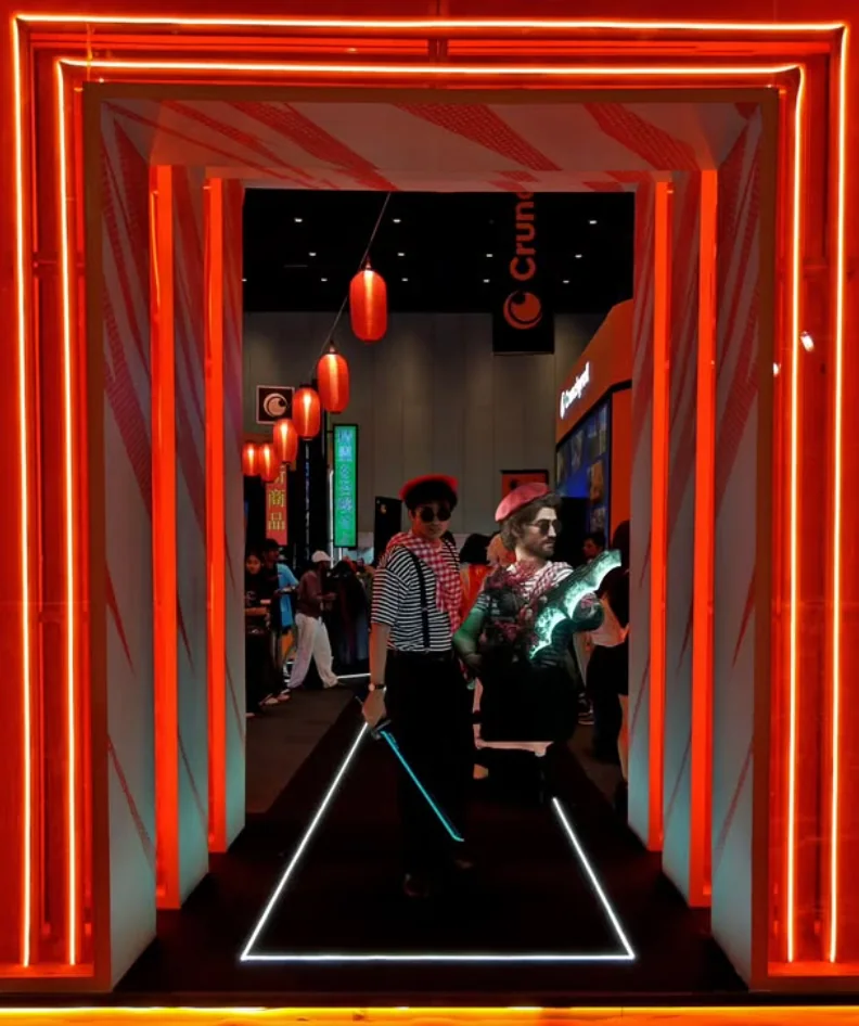 Two striped-costume convention portraits framed by red lights