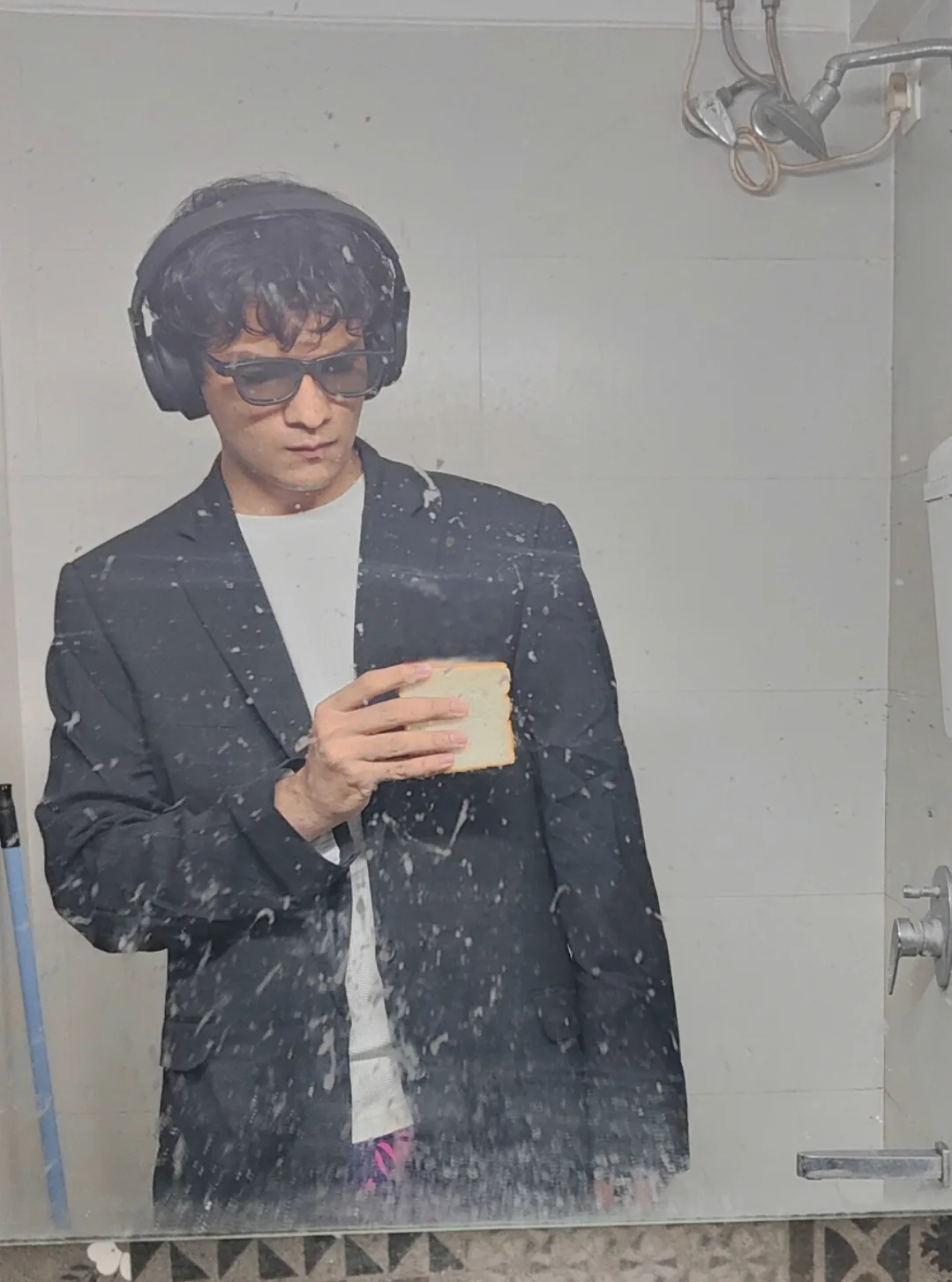 Mirror portrait in a blazer and headphones