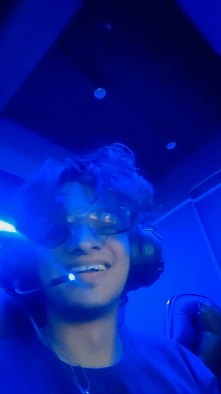 Blue-lit portrait wearing a gaming headset